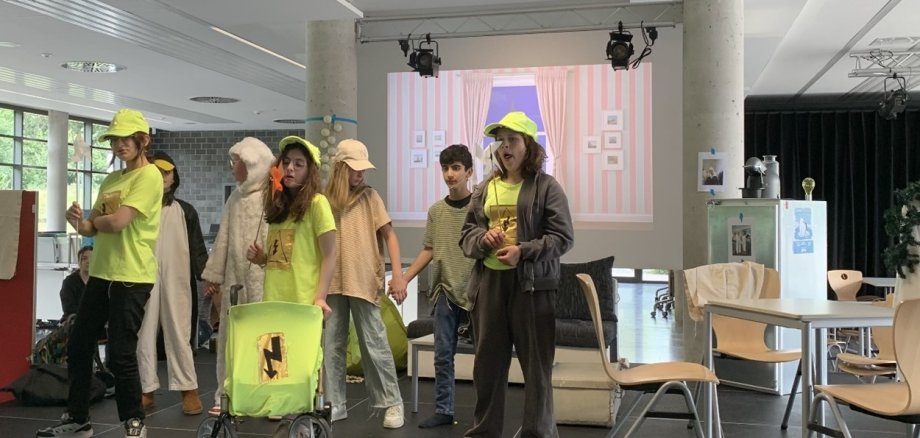 The pupils perform a scene from the play.